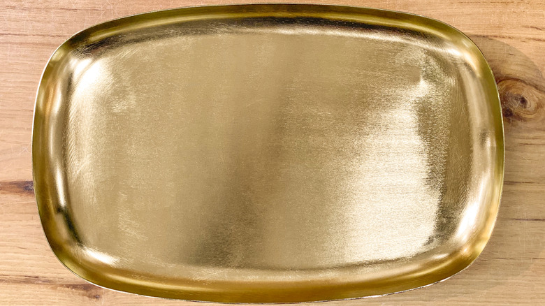 gold rectangular tray on wooden background