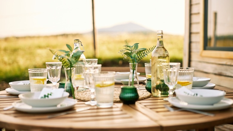 al fresco dining table with white place settings