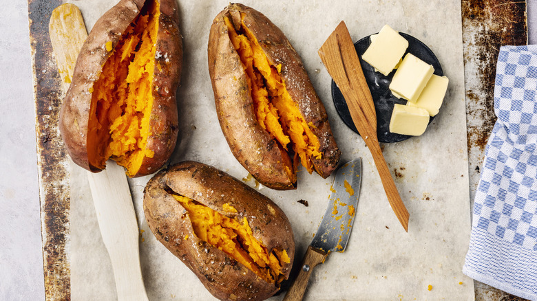 Three roasted sweet potatoes sliced down the middle