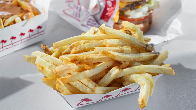In-N-Out fries in a container with burger in the background