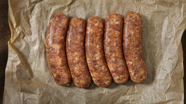 Uncooked andouille sausages on butcher paper.