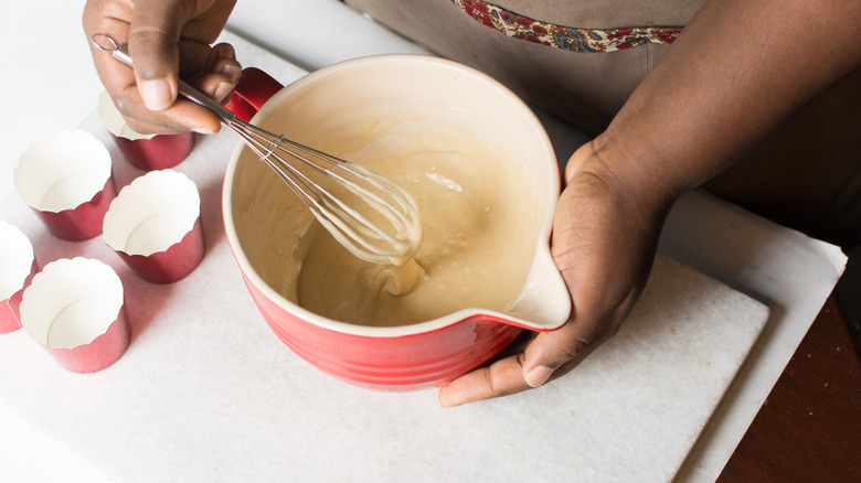 hands mixing muffin batter
