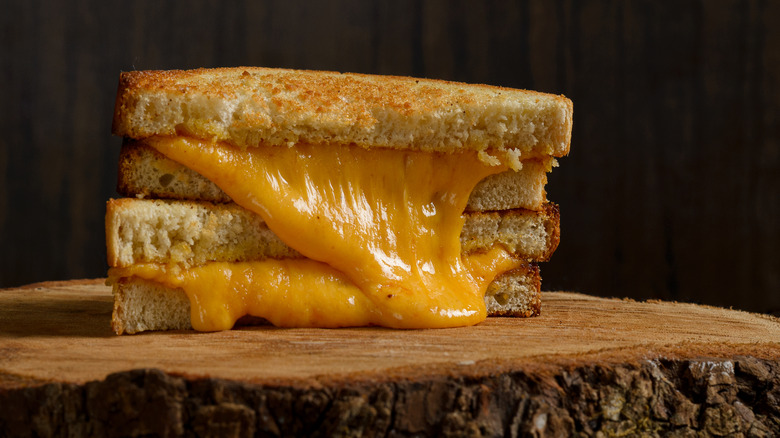 halved grilled cheese sandwich with gooey cheese