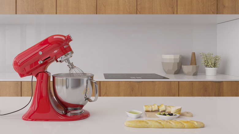 red kitchenaid mixer on a white counter