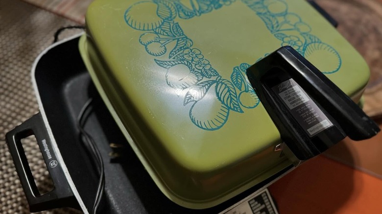 An electric skillet with a colorful lime green lid