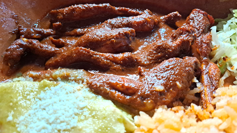 A saucy frog leg dish with several sides