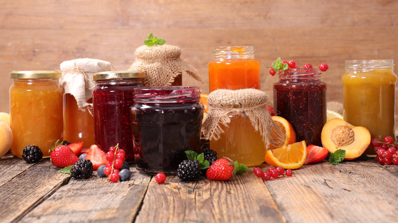 jars of jam, jelly and marmalade on a wooden surface