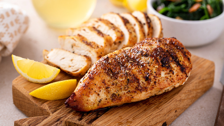 marinated grilled chicken breast on a cutting board