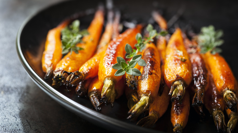 glazed carrots on a plate with herbs