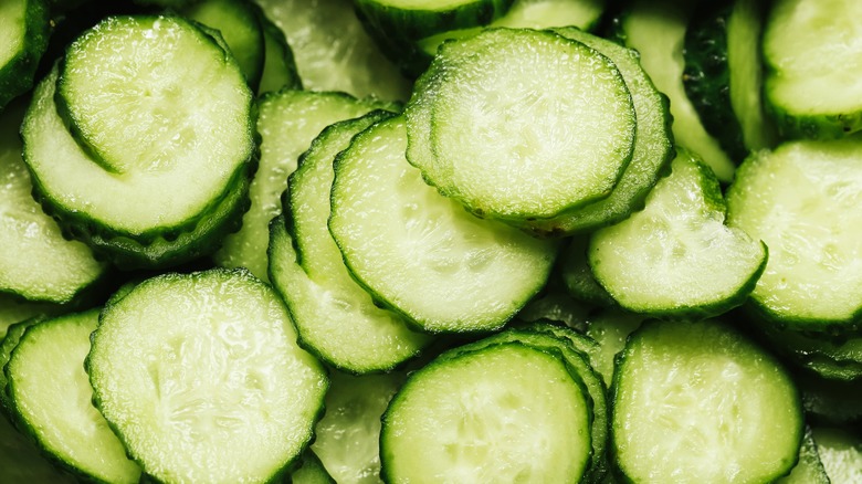 A close-up image of sliced raw cucumbers