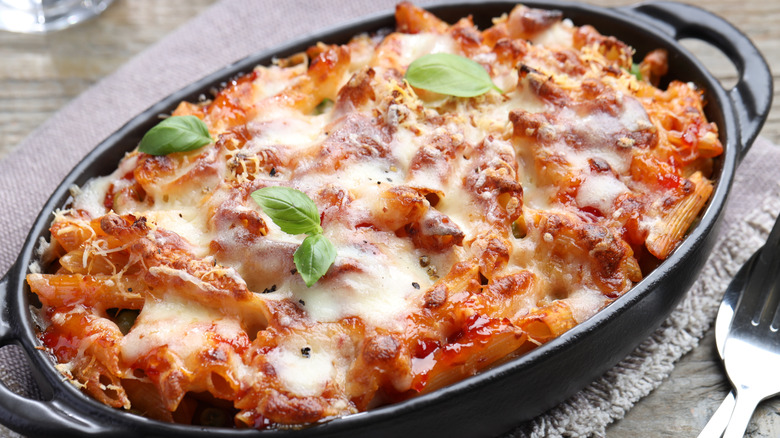 cheesy baked pasta in a black baking dish