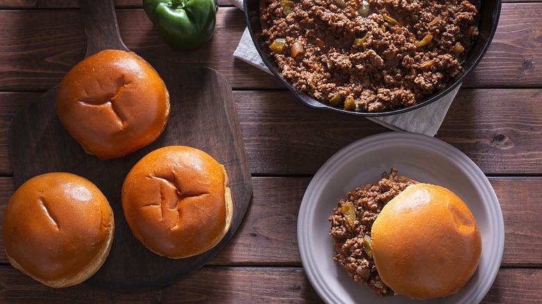 Overhead view of sloppy Joes served on a wooden surface