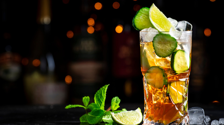 a Pimm's cup cocktail with lime, cucumber, and mint