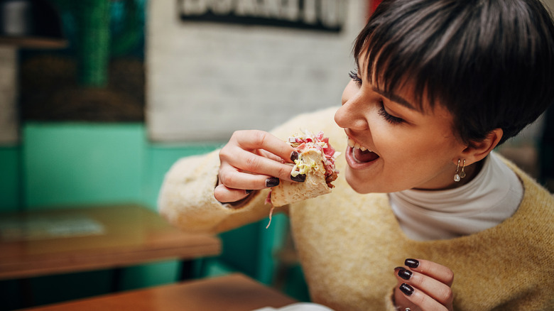 Woman eating a burrito