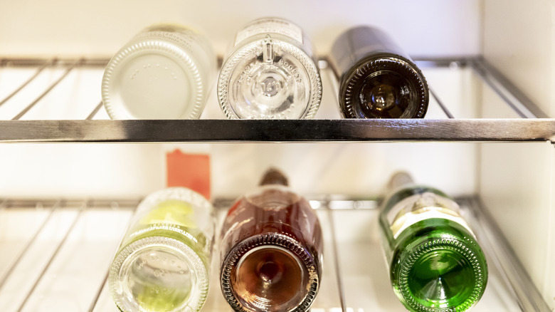 Refrigerator rack with bottled drinks laying on their sides