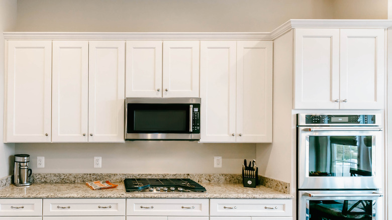 white kitchen cabinets with space above the ceiling