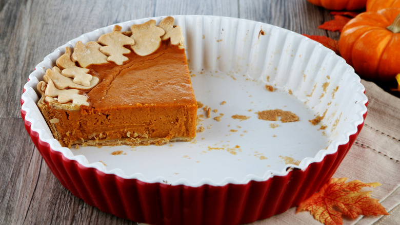 A slice of leftover pumpkin pie sitting in a pie dish