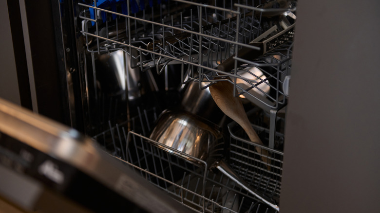 open dishwasher filled with pots