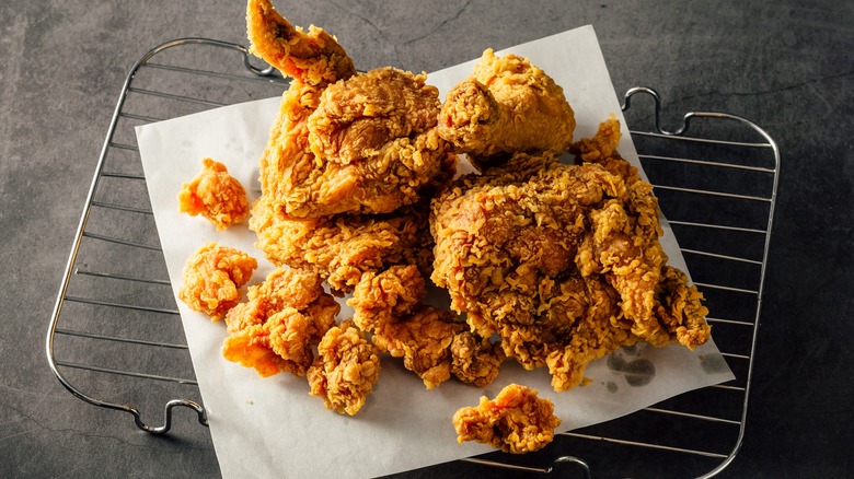 freshly fried chicken cooling on a wire rack
