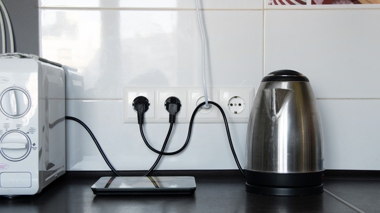 Small kitchen appliances plugged into the wall.