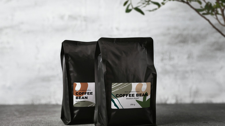 Coffee bean bags with a plant in the background