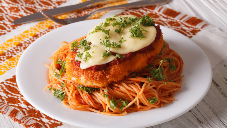 plate of chicken Parmesan on top of pasta