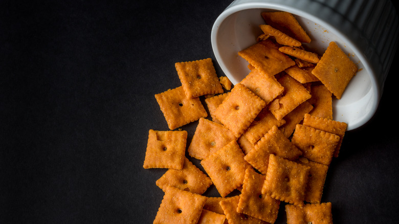 Cheez-Its crackers spilling out of a white bowl