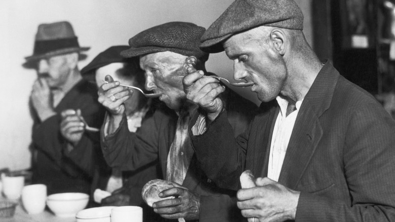 Workers eat soup during the Great Depression