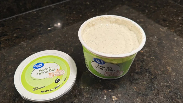 Container of Great Value French Onion Dip on a black table