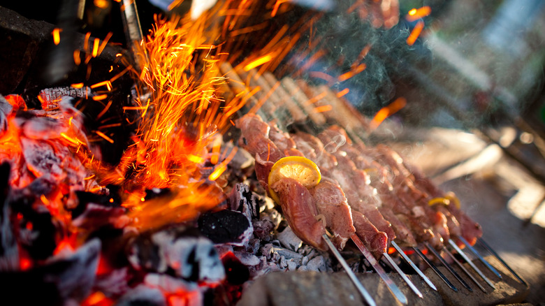 Food cooking on charcoal grill 