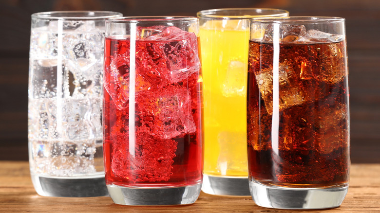 Glasses of soda on wood
