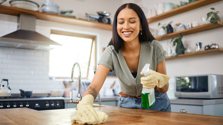 Woman cleaning kitchen counter