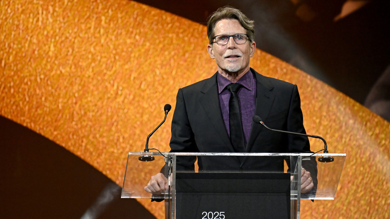 Rick Bayless standing at a podium