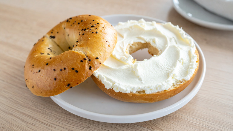 Sliced bagel with cream cheese in a plate