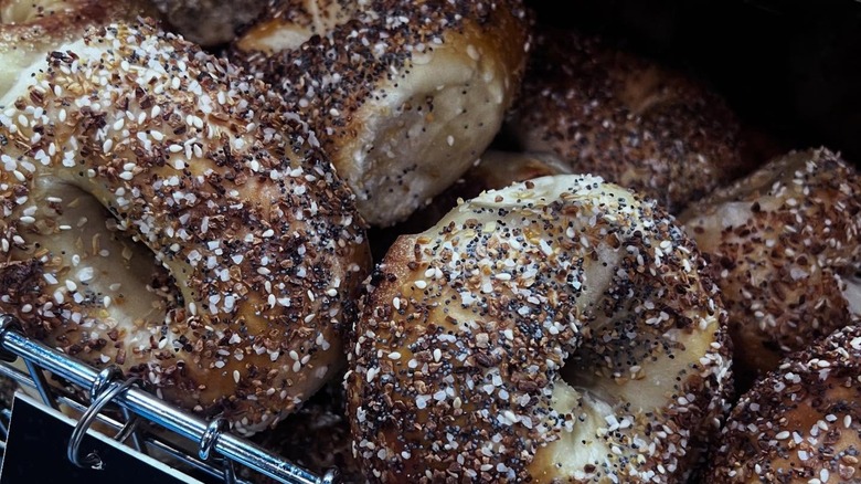 Close-up of everything bagels on wire rack