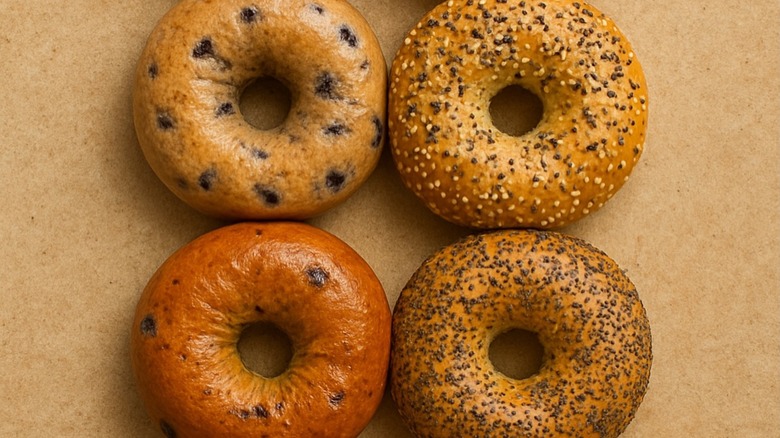Four assorted bagels on brown paper