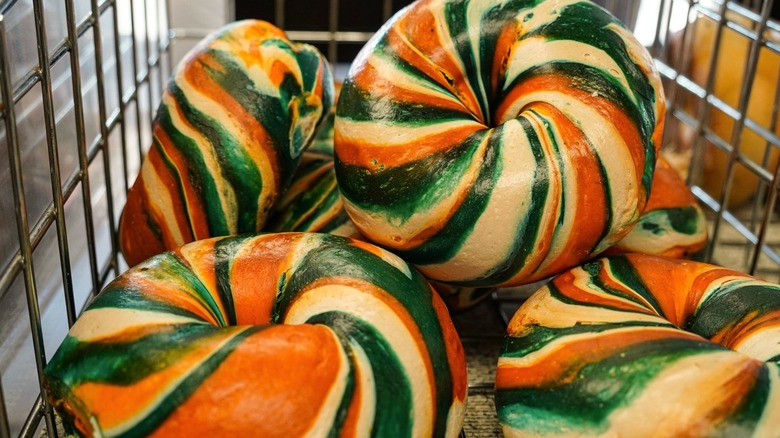 Colorful rainbow bagels in wire basket