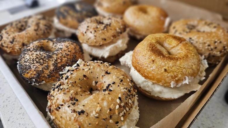 Assortment of sliced and filled bagels in a box