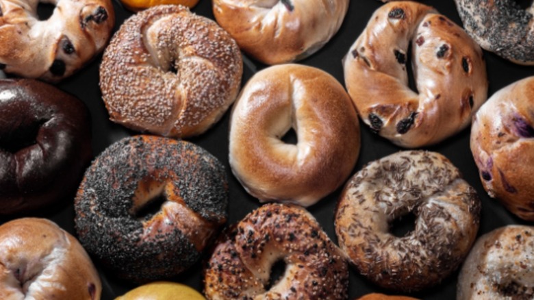 Assortment of bagels on black background