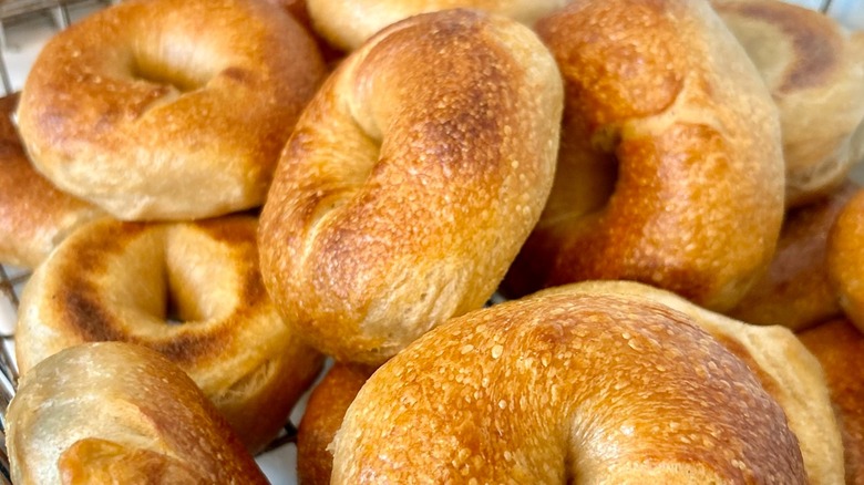 Pile of golden bagels in a wire bin