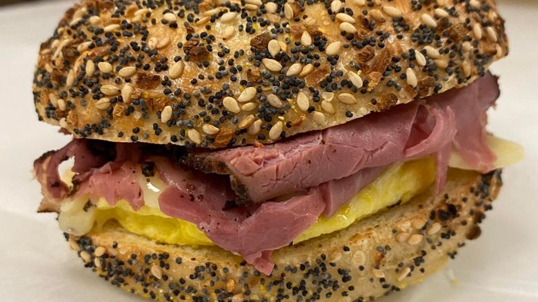 Pastrami, egg, and cheese on an everything bagel sandwich