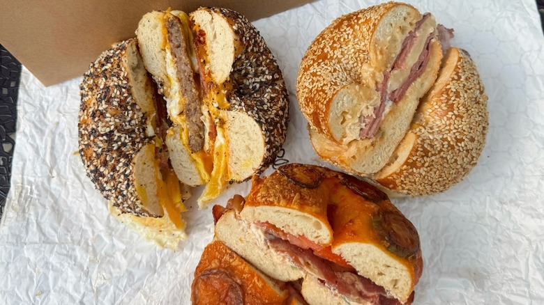 Three bagel breakfast sandwiches cut in half