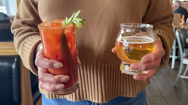 Woman holding Spenard's Bloody Mary with beer sidecar