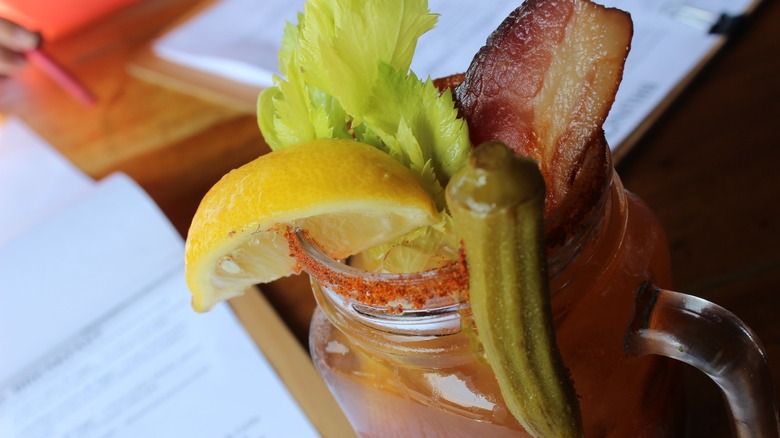 Bloody Mary closeup with okra, bacon, and lemon