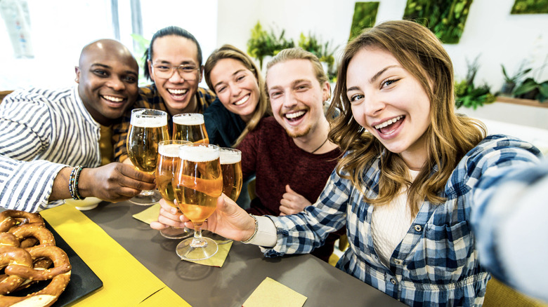 A group of people drinking beer on a brewery tour