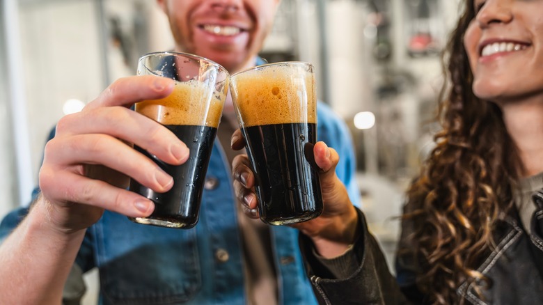 Two people drinking beer on a brewery tour