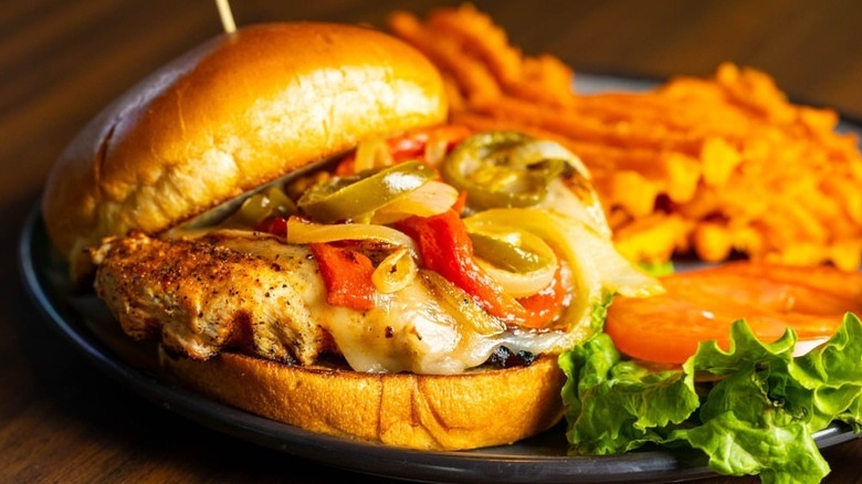 A cheeseburger with onions and peppers and sweet potato fries from Mike Duffy's.