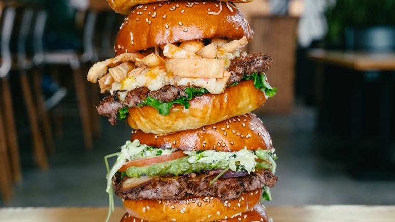 A stack of burgers at Chomp.