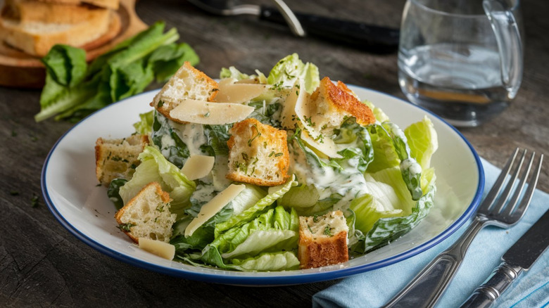 A Caesar salad on a table at a restaurant