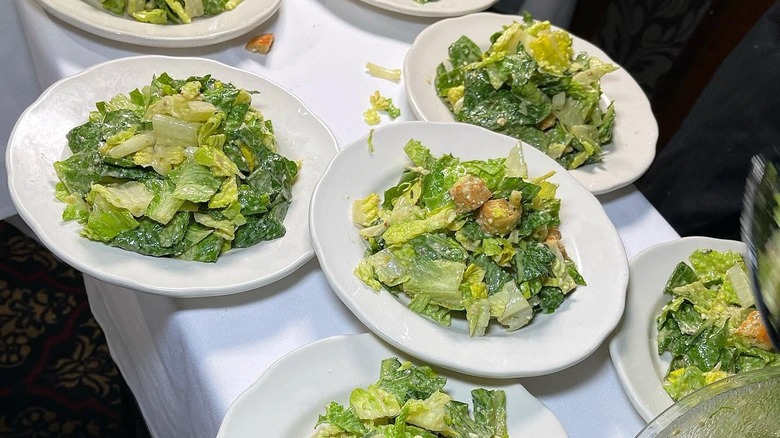 Multiple Caesar salads on a table at the Golden Steer